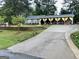 Inviting front yard featuring lush greenery, a spacious driveway, and a charming home with a covered porch at 140 Stoneview Cir, Covington, GA 30016