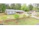 Inviting ranch-style home with spacious front yard, brick wall, manicured landscaping, and a covered front porch at 140 Stoneview Cir, Covington, GA 30016