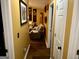 Hallway with yellow walls leading to a living room with brown furniture at 140 Stoneview Cir, Covington, GA 30016