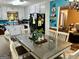 Eat-in kitchen boasts white cabinets, black appliances, and view to adjacent living space at 140 Stoneview Cir, Covington, GA 30016
