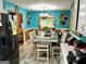 Stylish eat-in kitchen features a large dining table and a unique turquoise accent wall at 140 Stoneview Cir, Covington, GA 30016
