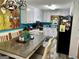 Bright eat-in kitchen with updated white cabinets, black appliances, and a spacious dining area at 140 Stoneview Cir, Covington, GA 30016