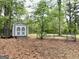 Practical outbuilding with double doors and ramp, perfect for storage and accessed from the fenced back yard at 140 Stoneview Cir, Covington, GA 30016