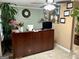 Professional reception area with a wooden desk, comfortable lighting, and stylish decorative accents at 140 Stoneview Cir, Covington, GA 30016