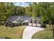 Stunning aerial view of the home showcases its well-manicured lawn, large three-car garage, and elegant exterior at 145 Carrington Ln, Brooks, GA 30205