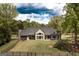 Aerial view of a home with a large, fenced backyard, screened porch, hot tub and lush greenery at 145 Carrington Ln, Brooks, GA 30205