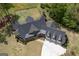 Expansive home features beautiful landscaping, a long driveway, and a spacious three-car garage at 145 Carrington Ln, Brooks, GA 30205