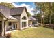Back of house shows a stone patio, a hot tub, a grill and outdoor seating perfect for entertaining at 145 Carrington Ln, Brooks, GA 30205