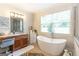 Beautiful bathroom featuring a soaking tub, vanity with a makeup area and a tiled floor at 145 Carrington Ln, Brooks, GA 30205