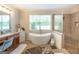 Bathroom boasts a soaking tub, walk-in shower, and dual vanities at 145 Carrington Ln, Brooks, GA 30205