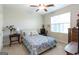 Cozy bedroom with floral bedding, bedside table, and natural light from the large window at 145 Carrington Ln, Brooks, GA 30205