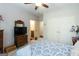 This cozy bedroom features neutral walls, carpeted floors, a ceiling fan, and a private bathroom at 145 Carrington Ln, Brooks, GA 30205
