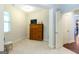 Carpeted bedroom features a wooden dresser and base trim around the walls at 145 Carrington Ln, Brooks, GA 30205