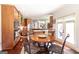 Sunlit breakfast nook with a wood table, decorative chairs, and views of the kitchen and patio at 145 Carrington Ln, Brooks, GA 30205
