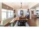 Dining room features hardwood floors, picture window, and rustic wood table at 145 Carrington Ln, Brooks, GA 30205