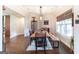 Dining area showcases a rustic wood table, large window, and hardwood floors at 145 Carrington Ln, Brooks, GA 30205