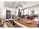 Dining room with wood table, hardwood floors, decorative pheasant and open floor plan at 145 Carrington Ln, Brooks, GA 30205