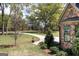 Manicured front yard features a curved driveway leading to the home, complemented by lush greenery at 145 Carrington Ln, Brooks, GA 30205