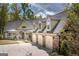 Beautiful home with a three-car garage and stone accents, surrounded by lush landscaping and a spacious driveway at 145 Carrington Ln, Brooks, GA 30205