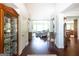Bright foyer featuring hardwood floors, a display cabinet, and views into the home's open living spaces at 145 Carrington Ln, Brooks, GA 30205