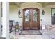 Inviting front entrance with double doors, stone accents, and decorative lanterns at 145 Carrington Ln, Brooks, GA 30205