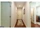 This bright foyer offers gorgeous wood floors, neutral paint, and access to the kitchen at 145 Carrington Ln, Brooks, GA 30205