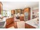 Well-equipped kitchen offers granite countertops, wood cabinets, and stainless steel appliances at 145 Carrington Ln, Brooks, GA 30205