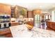 Gourmet kitchen features custom cabinetry, granite countertops, a stone alcove, and stainless steel appliances at 145 Carrington Ln, Brooks, GA 30205