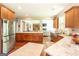 Bright, open kitchen with stainless steel appliances, granite countertops, and wood floors overlooking the living area at 145 Carrington Ln, Brooks, GA 30205