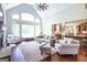 Well-lit living room with fireplace, hardwood floors, and a beautiful large window at 145 Carrington Ln, Brooks, GA 30205