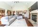 Bright living room boasts hardwood floors, stone fireplace, and comfortable seating arrangement at 145 Carrington Ln, Brooks, GA 30205