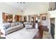 Bright open-concept living room features vaulted ceilings, a stone fireplace, and hardwood floors at 145 Carrington Ln, Brooks, GA 30205