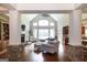 Bright living room features cathedral ceiling, fireplace, hardwood floors, and large windows at 145 Carrington Ln, Brooks, GA 30205