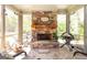 Stone fireplace on screened porch offers an inviting space for outdoor entertaining at 145 Carrington Ln, Brooks, GA 30205