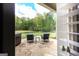 Stone patio with seating area overlooking a serene backyard and wooded area at 145 Carrington Ln, Brooks, GA 30205