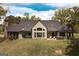 Beautiful rear exterior of a house, showing the fenced in yard, hot tub, and multiple windows at 145 Carrington Ln, Brooks, GA 30205