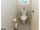 Clean and simple bathroom with toilet, toilet paper holder, decoratives, neutral colors and tile floors at 145 Carrington Ln, Brooks, GA 30205