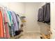 Organized walk-in closet with wire shelving, hanging rods, and a variety of clothing items neatly arranged at 145 Carrington Ln, Brooks, GA 30205