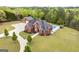 Aerial view of the brick home, detached garage, pool, and landscaped yard surrounded by trees at 2351 Rabbit Farm Cir, Loganville, GA 30052