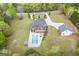 An aerial shot showcases a house with a pool and deck, complemented by a spacious green yard at 2351 Rabbit Farm Cir, Loganville, GA 30052