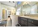 Well-lit bathroom boasts dual sinks, dark cabinetry, and adjacent access to the main bedroom at 2351 Rabbit Farm Cir, Loganville, GA 30052