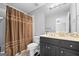 The bathroom includes a shower with a curtain, a toilet and a vanity at 2351 Rabbit Farm Cir, Loganville, GA 30052
