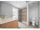 Well-lit bathroom featuring a single sink vanity, tiled shower with curtain, and toilet at 2351 Rabbit Farm Cir, Loganville, GA 30052