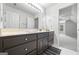 Bathroom features a large vanity with dark cabinets, mirror, and access to bedroom at 2351 Rabbit Farm Cir, Loganville, GA 30052