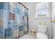 Bathroom features toilet, window, and blue shower curtain with designs at 2351 Rabbit Farm Cir, Loganville, GA 30052