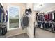 Spacious walk-in closet with ample shelving and a window with a view of the outside at 2351 Rabbit Farm Cir, Loganville, GA 30052