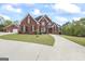 Charming two-story brick home featuring a circular driveway and a detached two-car garage at 2351 Rabbit Farm Cir, Loganville, GA 30052