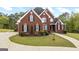 Beautiful brick home with manicured lawn and garden beds at 2351 Rabbit Farm Cir, Loganville, GA 30052