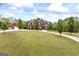 Traditional brick home with manicured lawn, circular drive, and detached two-car garage with guest suite at 2351 Rabbit Farm Cir, Loganville, GA 30052