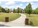 The front exterior includes mature trees, green grass, a brick mailbox and the circular driveway at 2351 Rabbit Farm Cir, Loganville, GA 30052
